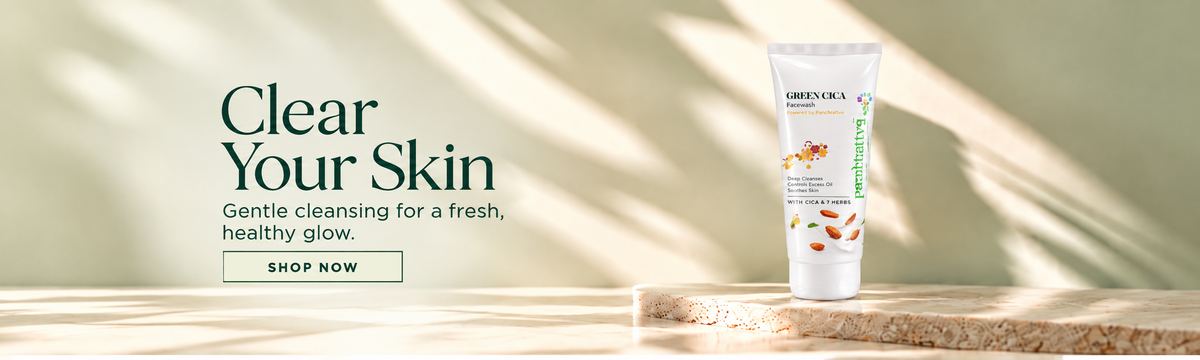 A skincare tube labeled Green Cica Facewash stands on a stone slab against a soft beige background with leaf shadows. Large text on the left reads 'Clear Your Skin' with a 'SHOP NOW' button below.